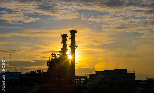 Silhouette of gas turbine power plant at sunset which create pollution and global warming cause ozone layer depletion for electricity and energy concept