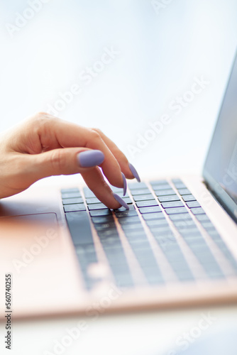 Purchases via the Internet and payment for services buy credit card. Hands type text and enter data on the laptop keyboard. An office worker checks his email while sitting at his desk