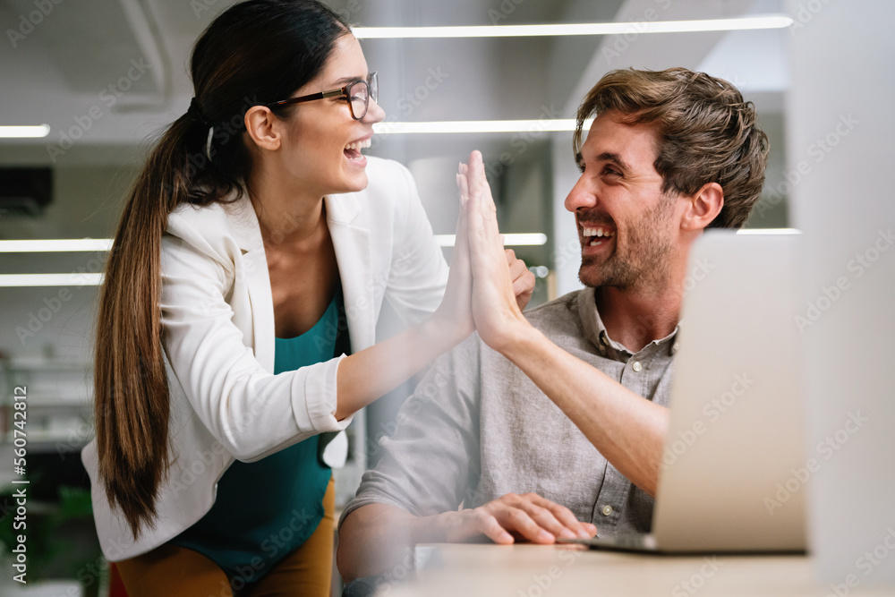 Happy group of multiethnic business people celebrating success at company Happy group of multiethnic business people celebrating success at company