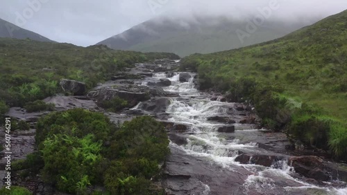 Aerial View Of Water Cascading Down Craggy Rocks In Isle Of Skye. Dolly Back photo