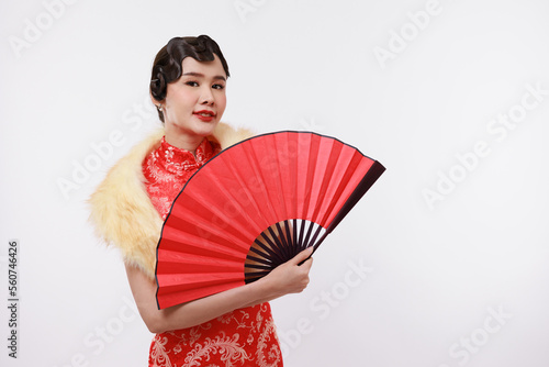 Smiling young beautiful woman holding a red fan in traditional dress on isolated white background.