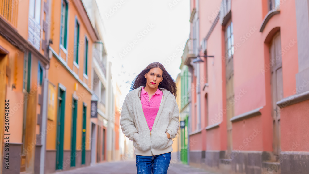 Beauty transgender woman in colorful wall looking at camera Beauty transgender woman in colorful wall looking at camera