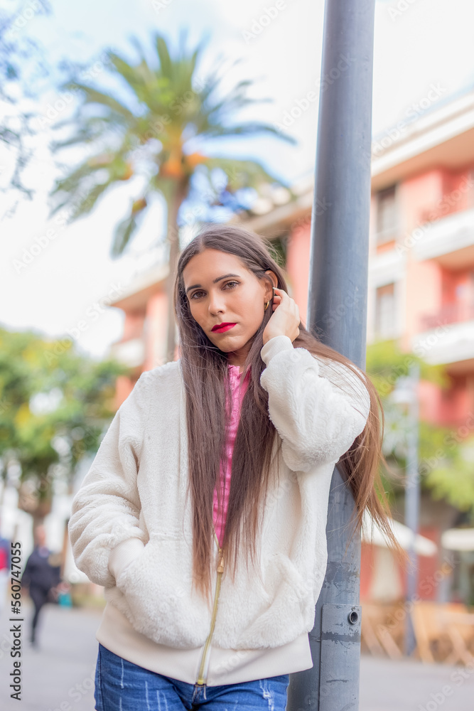 Fototapeta premium Beauty transgender woman in colorful wall looking at camera