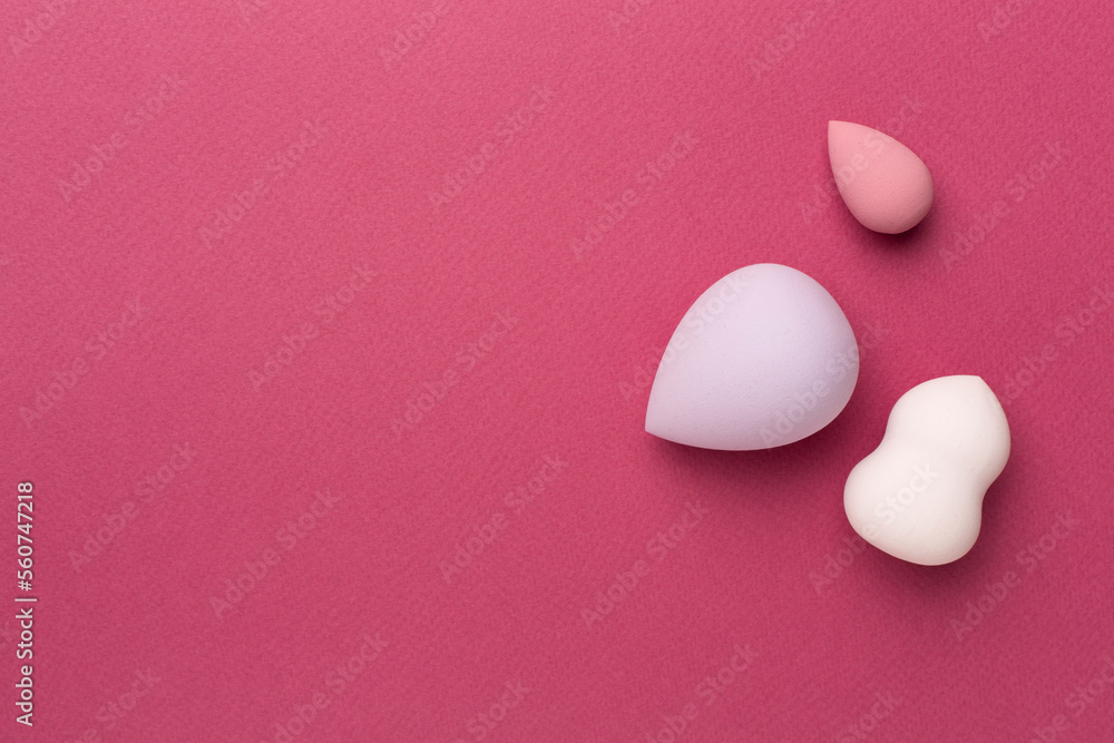 Fototapeta premium Beauty blenders on color background, top view