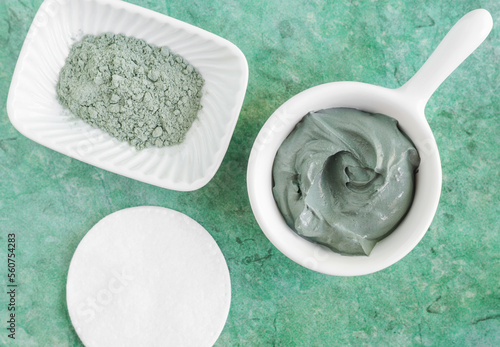 Green (blue, grey) bentonite clay in a bowl. Clay texture close up. Diy mask and body wrap recipe. Natural beauty treatment and spa. Top view, copy space photo