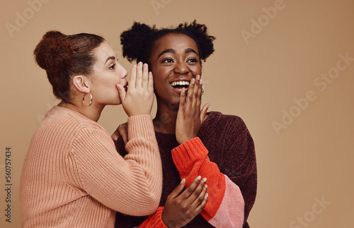 Friends, gossip and black woman laughing at secret on studio background and product placement mockup. Secrets, rumor and surprise whisper in ear, happy women smile discuss discount sale announcement