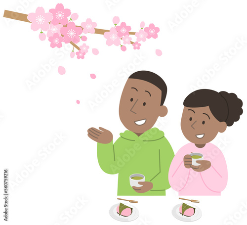 お花見をする外国人旅行者のカップル