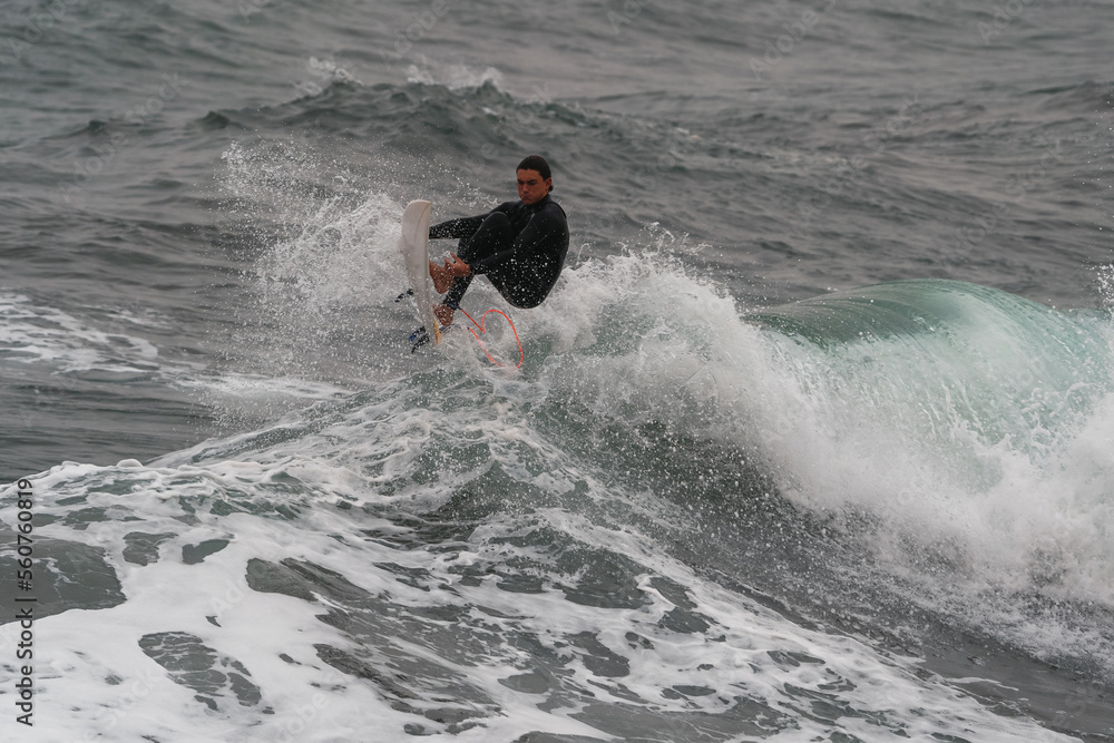 movement 2. young man surfs a wave and fails in Telde. Gran Canaria. Canary Islands