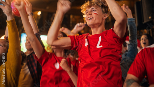 Close Up Portraits of a Diverse Group of Supportive Soccer Fans with Painted Faces Standing in a Bar, Cheering for Their Team. Raising Hands and Shouting. Friends Celebrate Victory After the Goal.