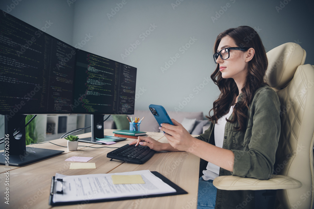 Profile side photo of serious smart lady pc operator hold telephone ...