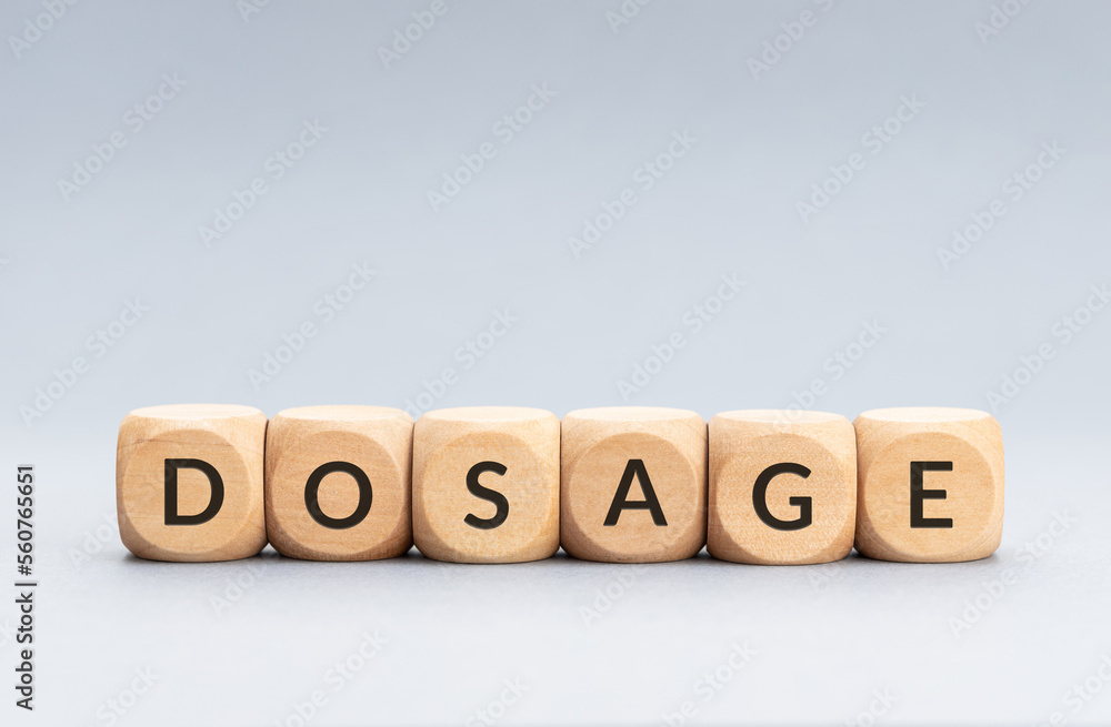 Dosage word on wooden blocks on gray background. Copy space Dosage word on wooden blocks on gray background. Copy space