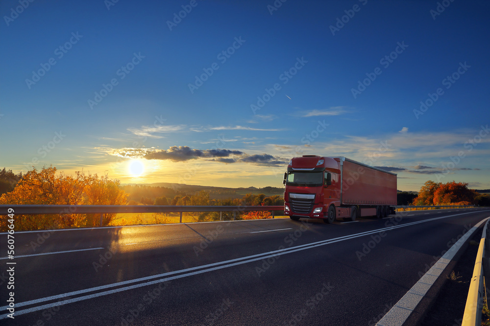 Truck transport on the road at sunset and cargo