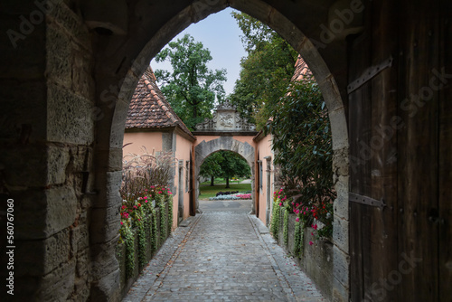 Fototapeta Naklejka Na Ścianę i Meble -  View through the Burgtor city gate on the gardens in the medieval German town of Rothenburg ob der Tauber.