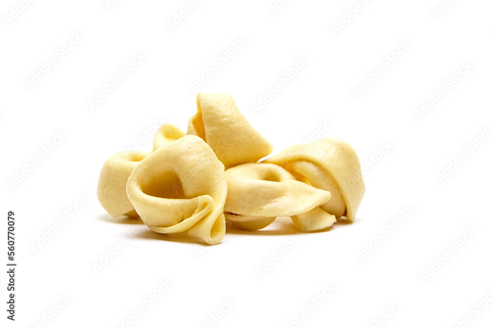 Tortellini stuffed pasta isolated on white background, closeup. Tortellini with raw prosciutto. Italian food Tortellini stuffed pasta isolated on white background, closeup. Tortellini with raw prosciutto. Italian food