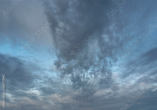 Dark, altocumulus clouds against bright, blue sky. photo