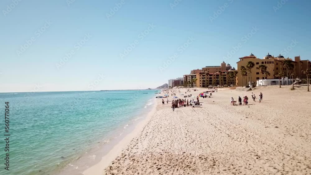 Drone shot of tourists relaxing on a warm beach in Mexico. Drone shot of tourists relaxing on a warm beach in Mexico.