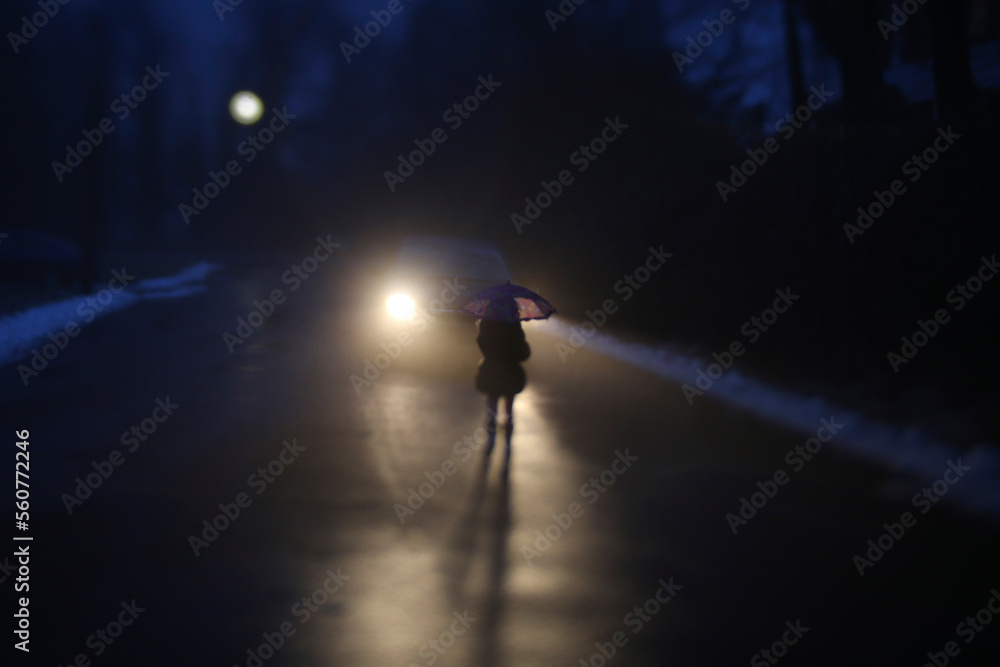 Silhouette girl with umbrella standing by car on road during winter Silhouette girl with umbrella standing by car on road during winter