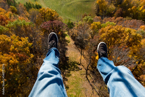 Feet hanging over tree tops during the fall