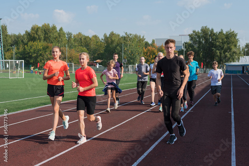 Group of young athletes training at the stadium. School gym trainings or athletics