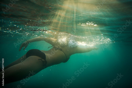 A young woman swimming in the beach in Nafpaktos, Greece. photo