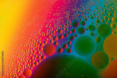 Macro photography of the oil drops on the water surface.Cosmic circles looks like molecule structure.Backdrop with copy space,good as template.