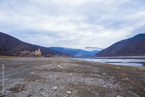 Ananuri, Georgia : 20-11-2022 : Landscape of  Aragvi River next to the  Ananuri castle complex, close Tblisi, Georgia, . It is a dry river in  a cloudy day in winter photo