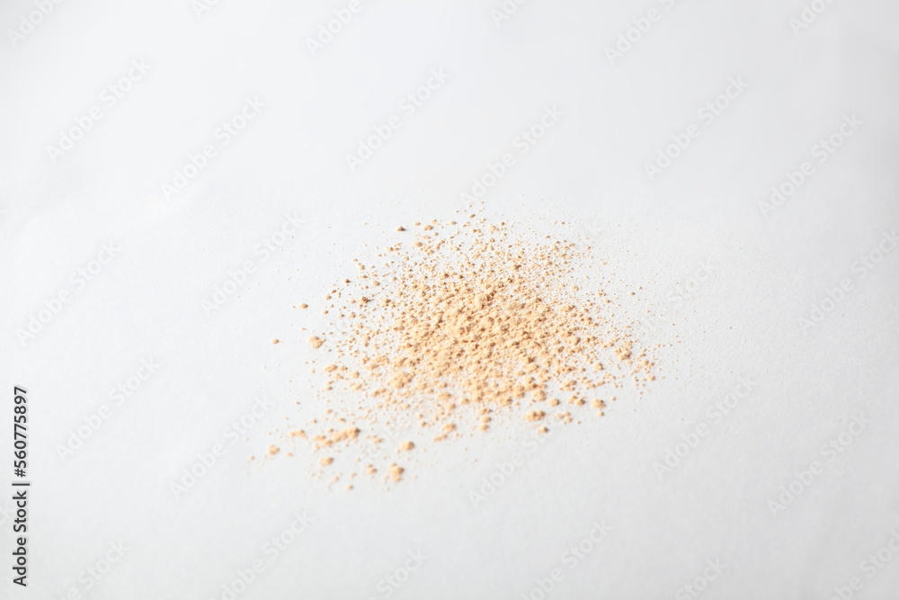 Shattered face powder on white background. Make up powder texture close up. Scattered matte powder. Shattered face powder on white background. Make up powder texture close up. Scattered matte powder.