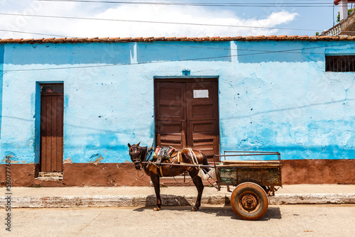 Old blue colonial house and a horse cart in the center of Trinidad, Cuba, Caribbean