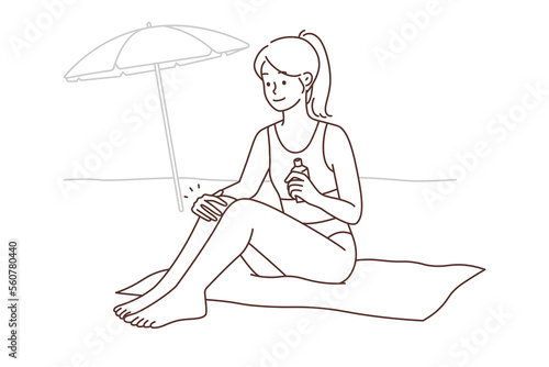 Smiling woman apply sunscreen sunbathing on beach 