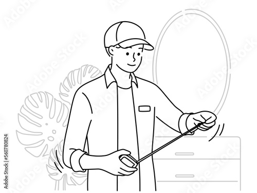 Male mechanic with tape measure work in room