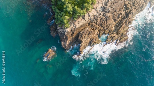 Aerial view of cliff and waves at Sri Lankan Beach. 
