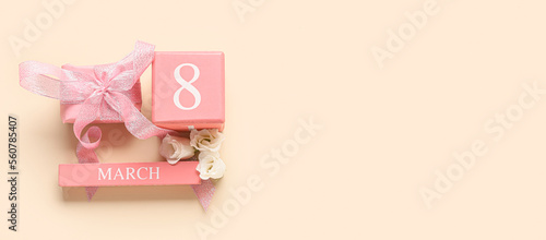 Calendar with date of International Women's Day, gift and flowers on light background with space for text © Pixel-Shot