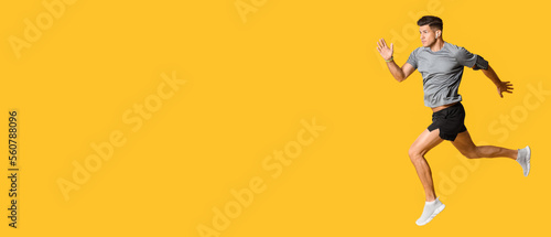 Sporty running man on yellow background with space for text