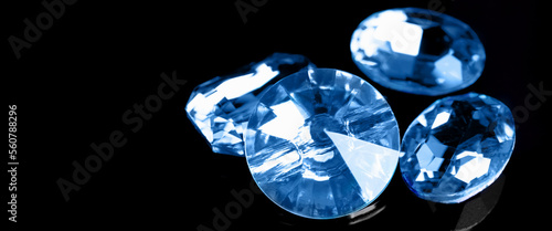 Precious blue stones for jewellery on dark background with space for text