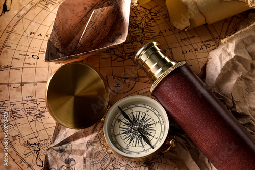 Compass and spyglass on wor...