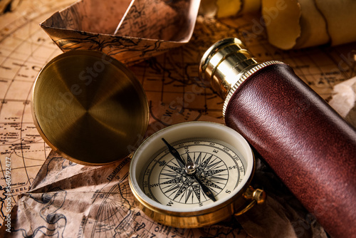 Compass and spyglass on wor...