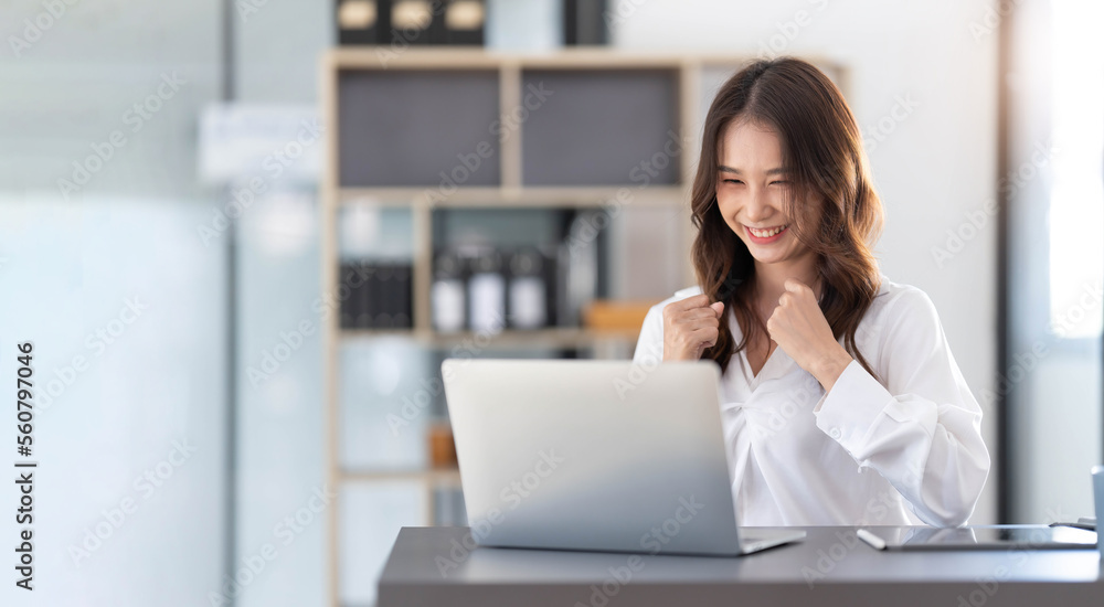 Beautiful asian woman using laptop computer, exciting and celebrating with good news of business successful. Small business startup concept. Beautiful asian woman using laptop computer, exciting and celebrating with good news of business successful. Small business startup concept.