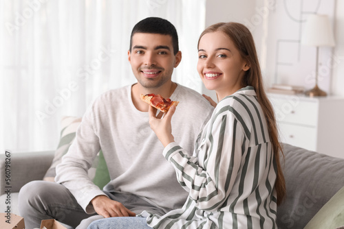 Happy young couple eating t...