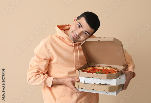 Young man with boxes of tas...