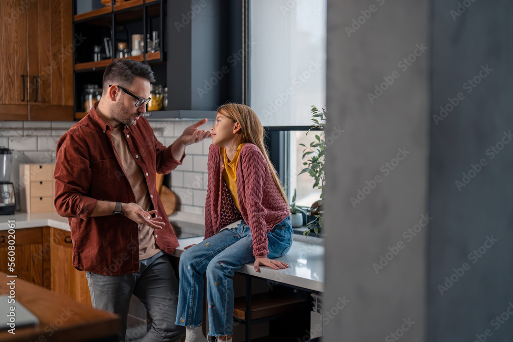 Caring father and his sweet young daughter solving a problem, finding a solution with simple conversation. Conversation and support in family. Caring father and his sweet young daughter solving a problem, finding a solution with simple conversation. Conversation and support in family.