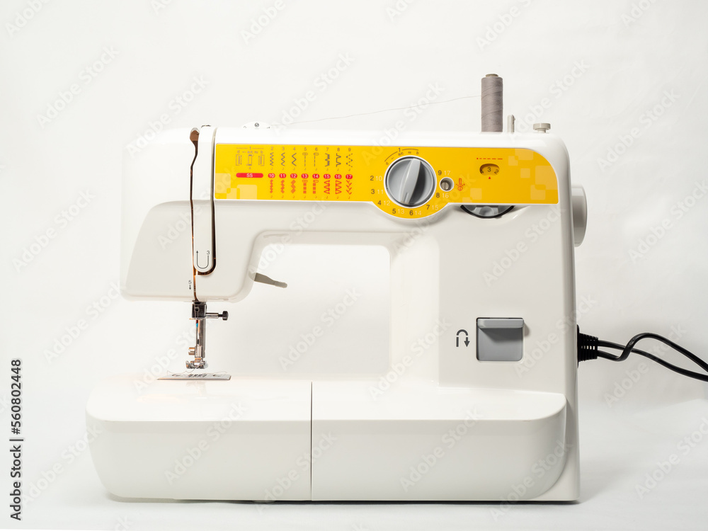 Electric sewing machine on a white background.