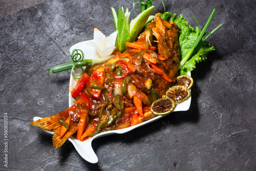 Fotografija Red Snapper fish hot sauce served in dish isolated on grey background top view o
