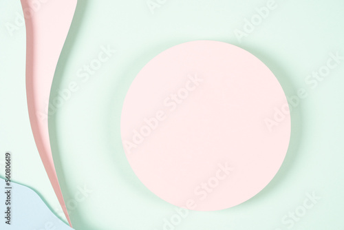 Blank pink round geometric shape podium platform on paper cut abstract geometric shape pastel pink  blue and green background. Top view mock up for product display