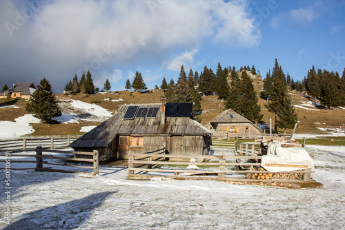 Velika planina mountain 1666 m in Kamnik Savinja Alps in Slovenia, winter hiking in herdsmen’s huts village covered with snow