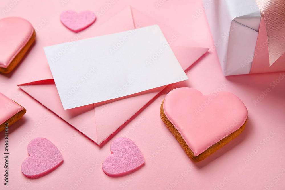 Composition with blank card, tasty cookies and decor on pink background, closeup. Valentines Day celebration