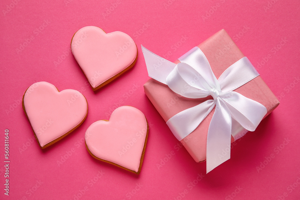 Beautiful gift box and heart shaped cookies on color background. Valentines Day celebration