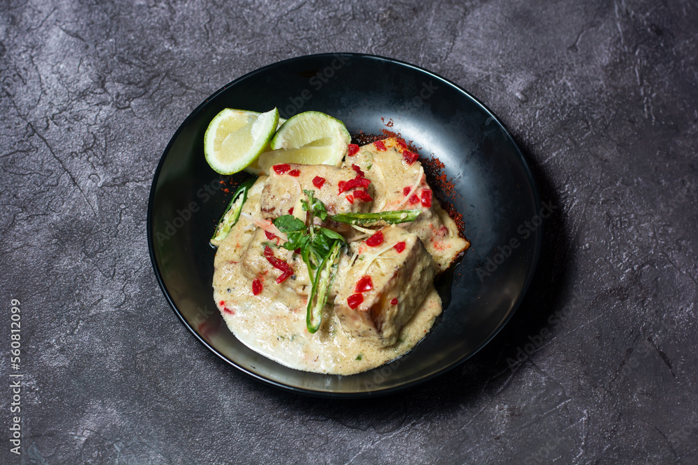 Navratan Korma with lime served in dish isolated on grey background top view of indian and bangladesh food Navratan Korma with lime served in dish isolated on grey background top view of indian and bangladesh food