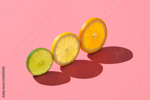 Fototapeta Naklejka Na Ścianę i Meble -  Citrus fruits variety, single slices isolated on a pink background.