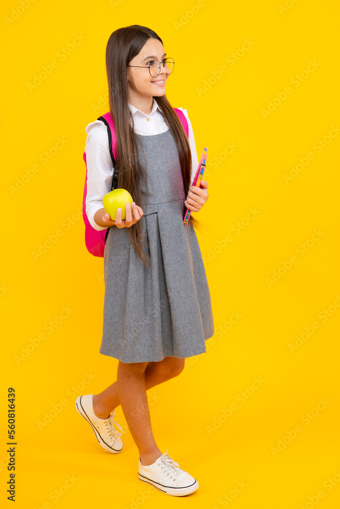 Schoolgirl in school uniform hold apple. School and education concept. Back to school. Schoolchild, teenage student studying. Schoolgirl in school uniform hold apple. School and education concept. Back to school. Schoolchild, teenage student studying.