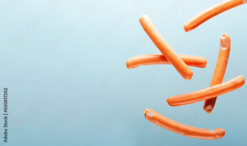 Sausages Levitating, Flying Food Concept on Light Blue background Sausages Levitating, Flying Food Concept on Light Blue background